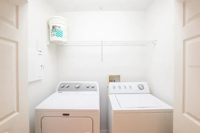 a room with a bed and a television