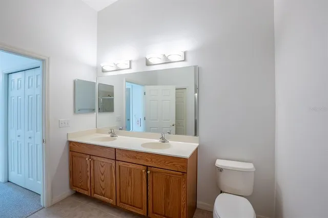 a view of a lake with a yard from a balcony