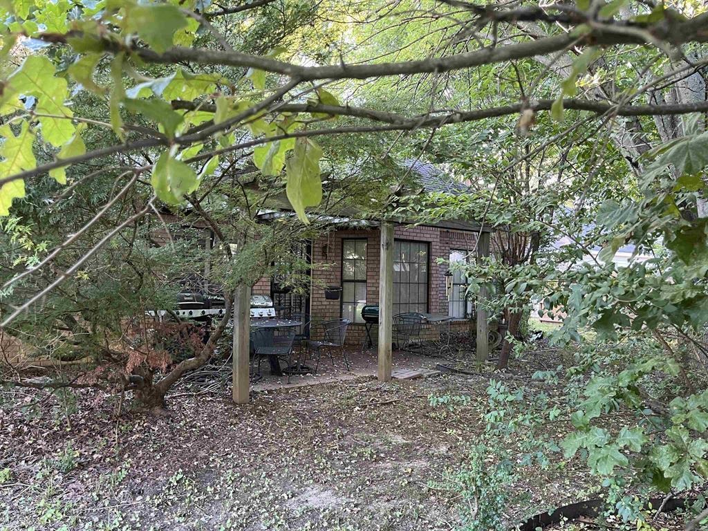 4066 Canada Road Lakeland, TN 38002 - Photo 2 of 5 a backyard of a house with barbeque oven table and chairs