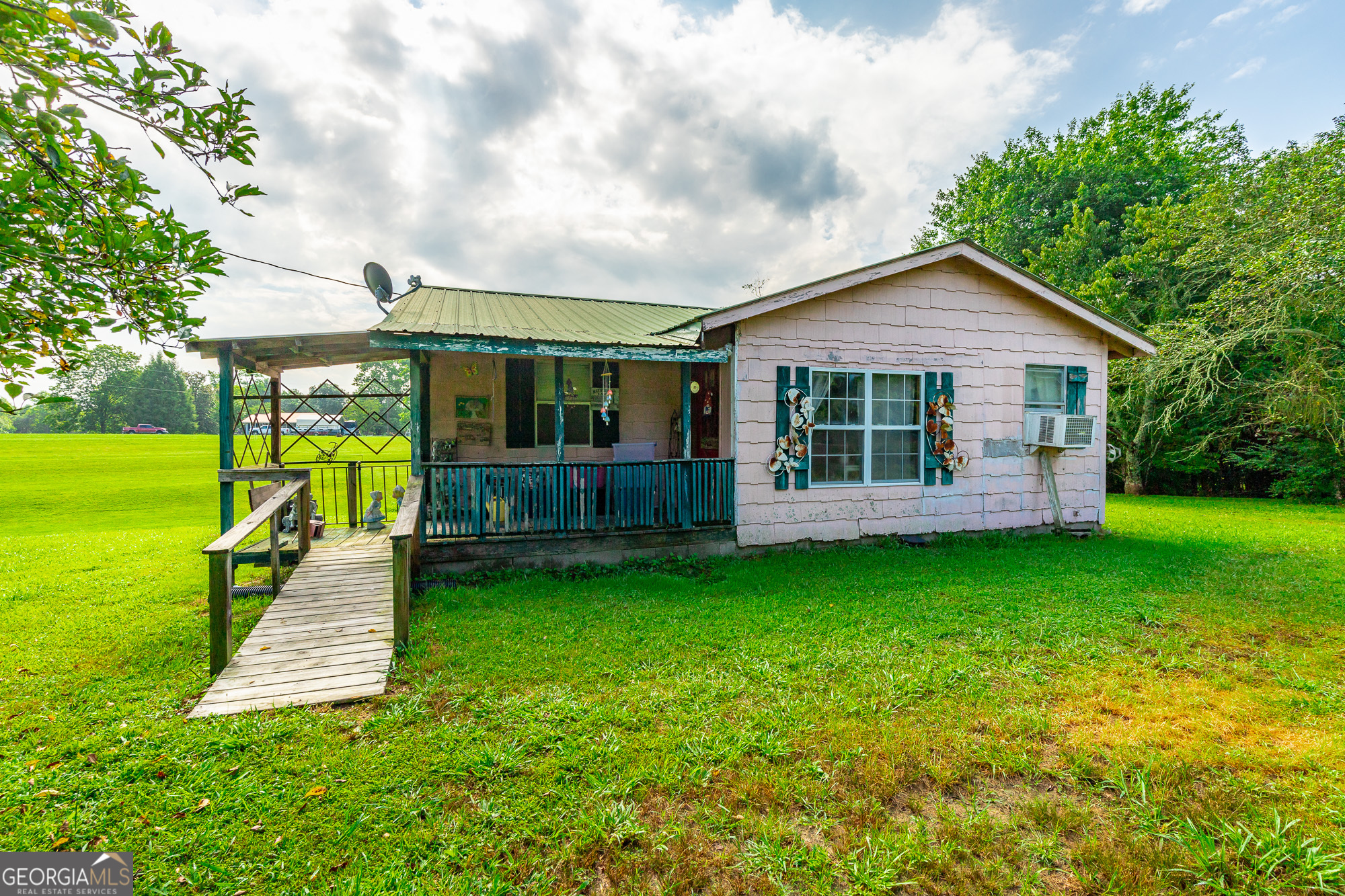 77 Bolton Road Trenton, GA 30752 - Photo 6 of 47 a view of a house with a backyard and a patio