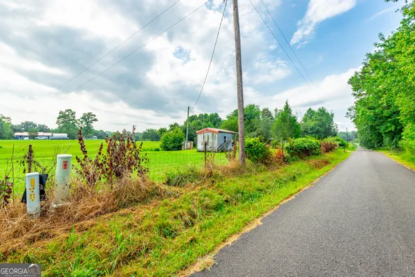 a view of a garden with a building in the background