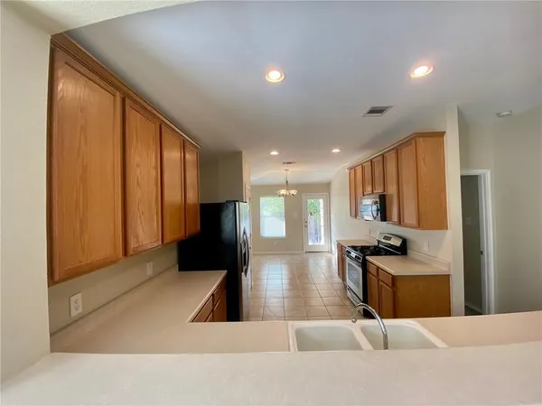 a view of a living room and kitchen