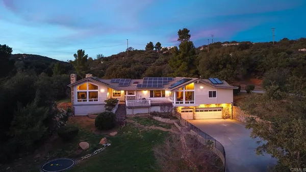 an aerial view of a house with a big yard