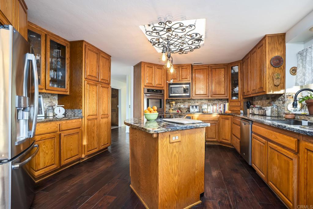 23002 Japatul Valley Road Alpine, CA 91901 - Photo 11 of 65 a kitchen with stainless steel appliances granite countertop a stove a sink and a refrigerator