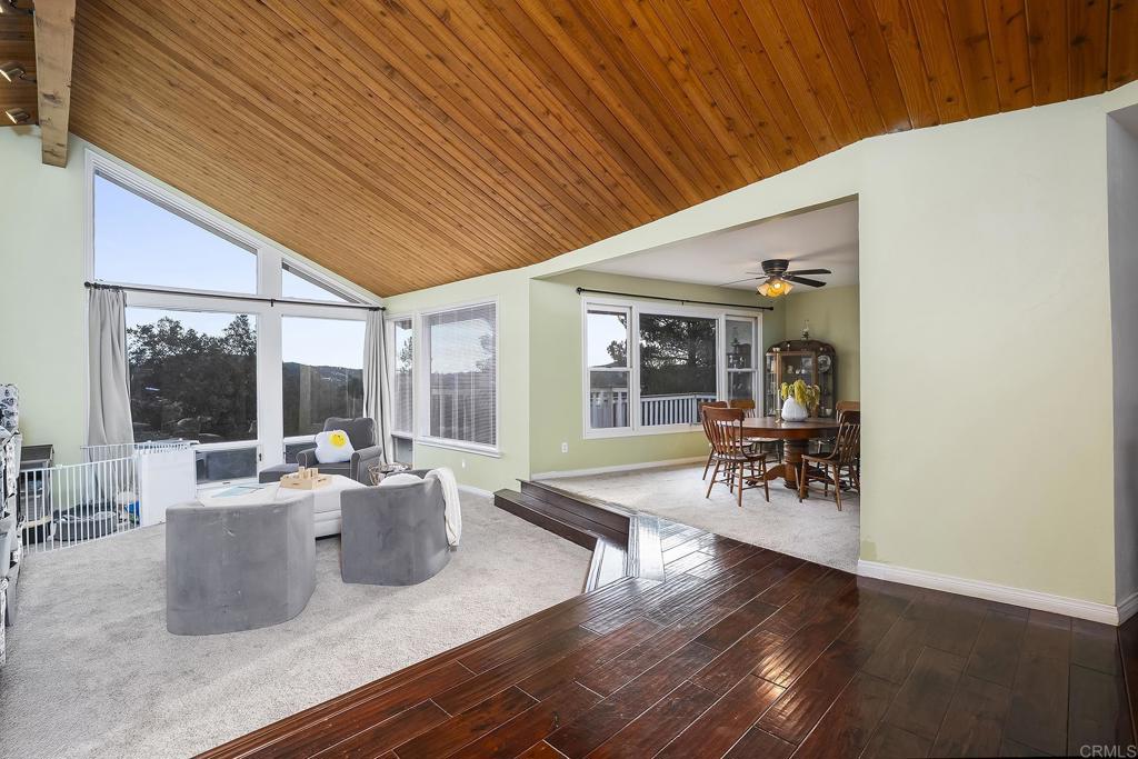23002 Japatul Valley Road Alpine, CA 91901 - Photo 18 of 65 a living room with furniture a wooden floor and a table