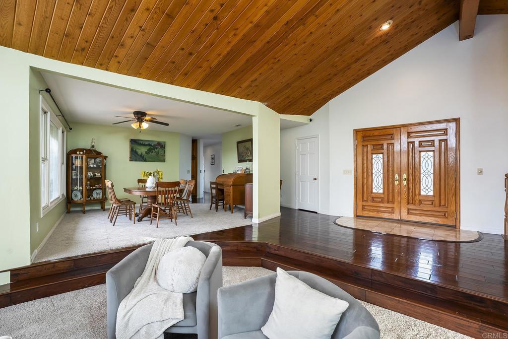23002 Japatul Valley Road Alpine, CA 91901 - Photo 19 of 65 a view of a dining room with furniture window and wooden floor
