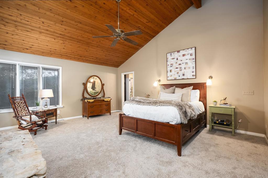 23002 Japatul Valley Road Alpine, CA 91901 - Photo 32 of 65 a bedroom with a bed and a chandelier