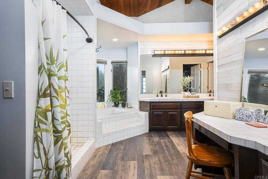 23002 Japatul Valley Road Alpine, CA 91901 - Photo 35 of 65 a large white kitchen with a large window and stainless steel appliances