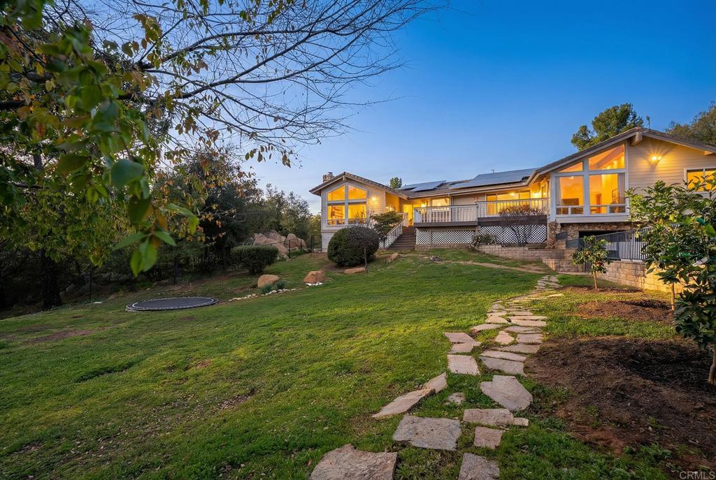23002 Japatul Valley Road Alpine, CA 91901 - Photo 40 of 65 a backyard of a house with table and chairs
