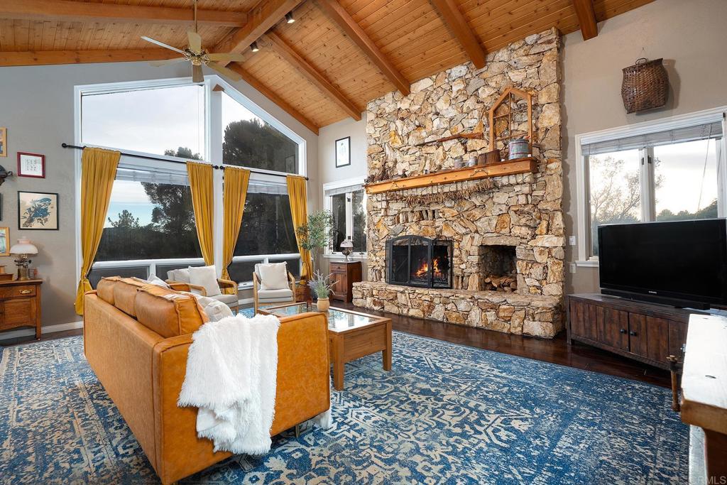 23002 Japatul Valley Road Alpine, CA 91901 - Photo 9 of 65 a living room with fireplace furniture and a flat screen tv