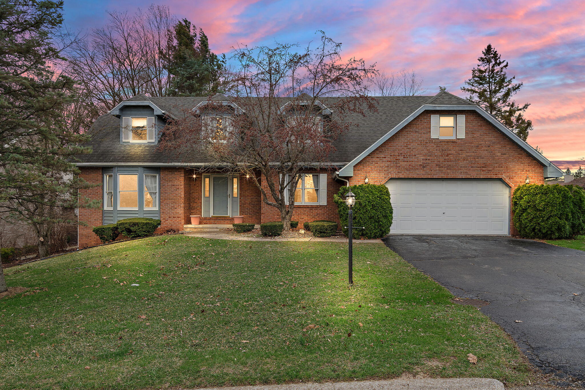 a front view of a house with a yard and garage