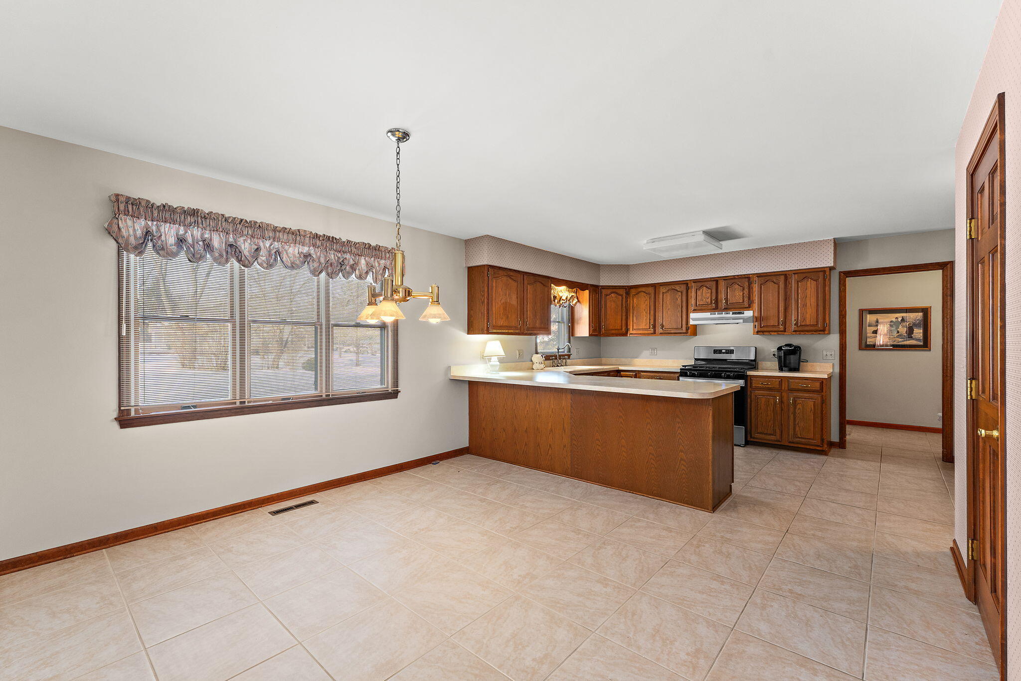 176 Wexford Road Valparaiso, IN 46385 - Photo 12 of 47 a kitchen with stainless steel appliances granite countertop a stove sink and cabinets