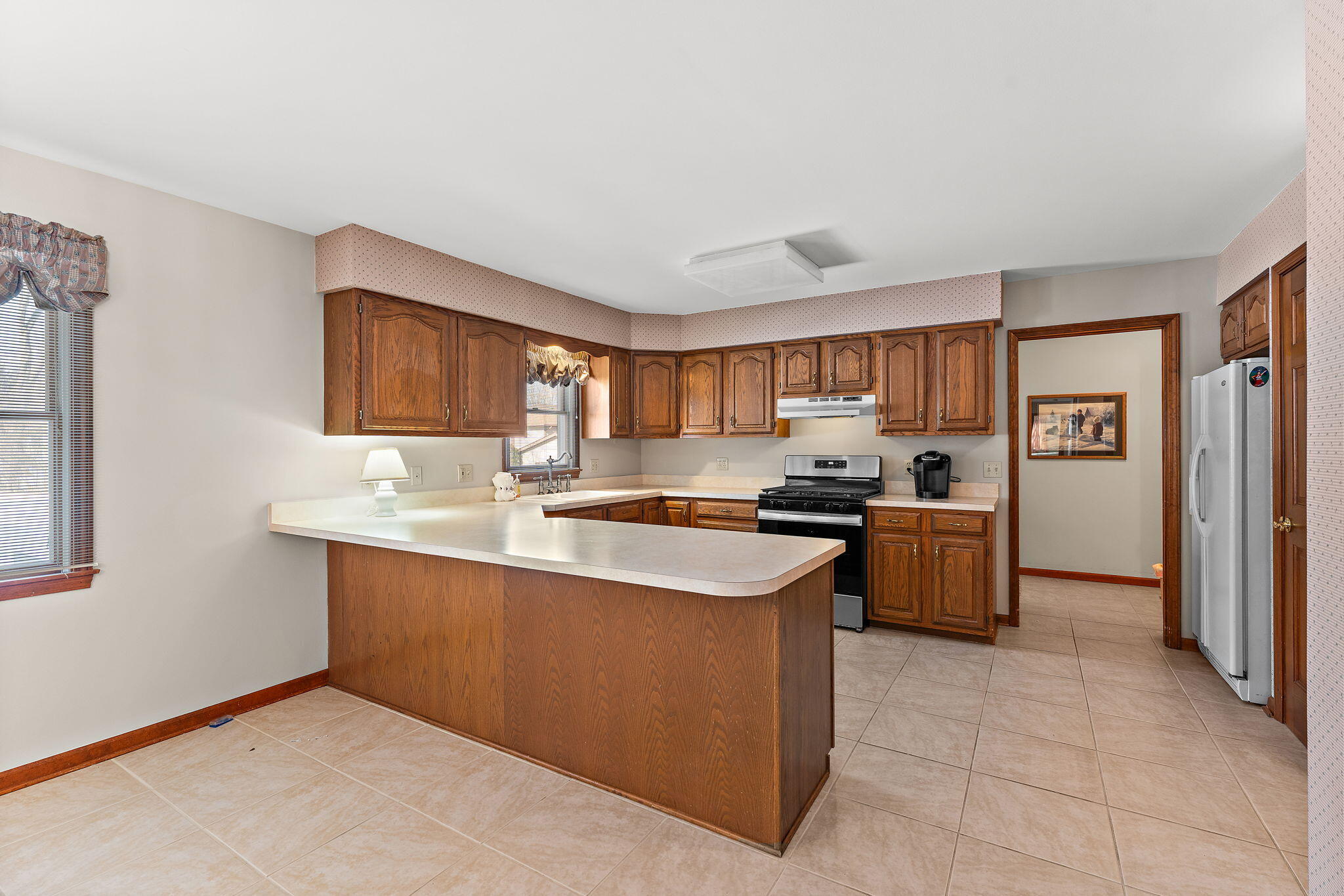 176 Wexford Road Valparaiso, IN 46385 - Photo 17 of 54 a kitchen with stainless steel appliances granite countertop a sink and a refrigerator