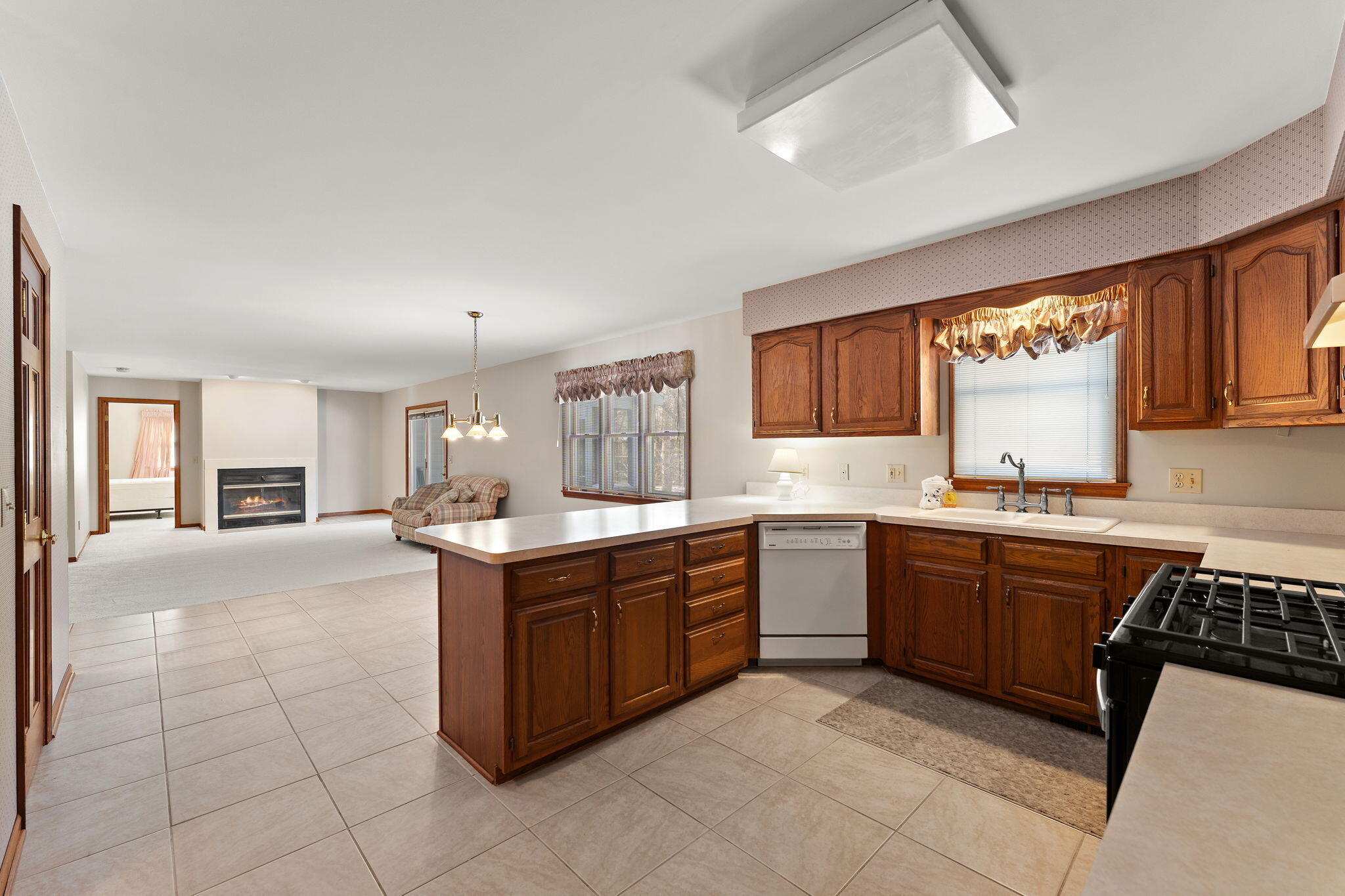 176 Wexford Road Valparaiso, IN 46385 - Photo 17 of 47 a large kitchen with kitchen island granite countertop a sink counter top space and cabinets