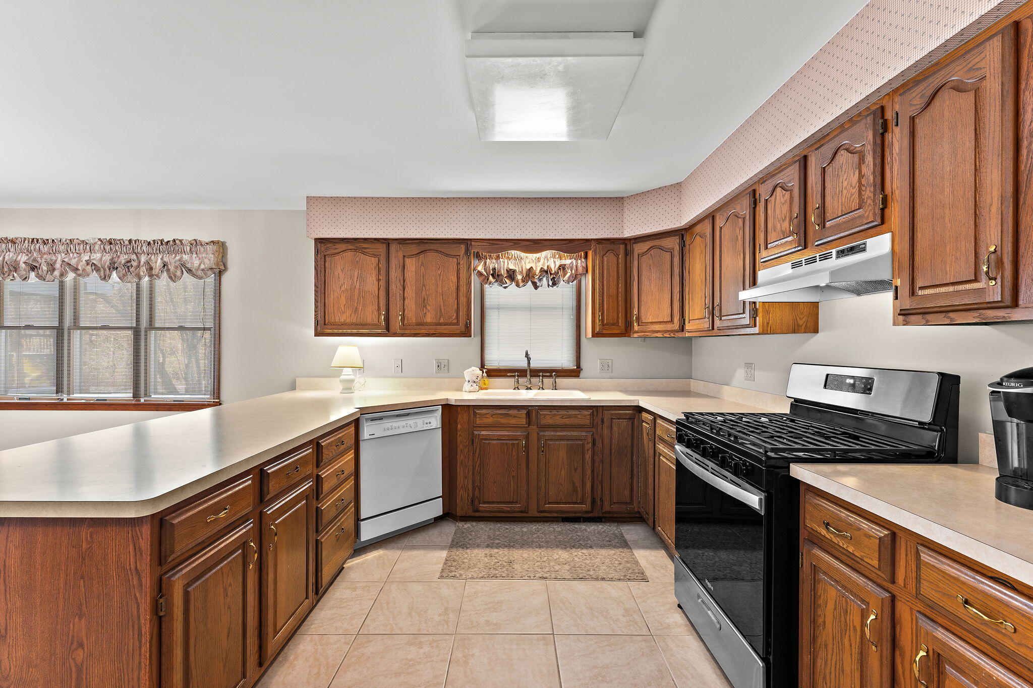 176 Wexford Road Valparaiso, IN 46385 - Photo 18 of 54 a kitchen with stainless steel appliances granite countertop stove a sink dishwasher and cabinets with wooden floor