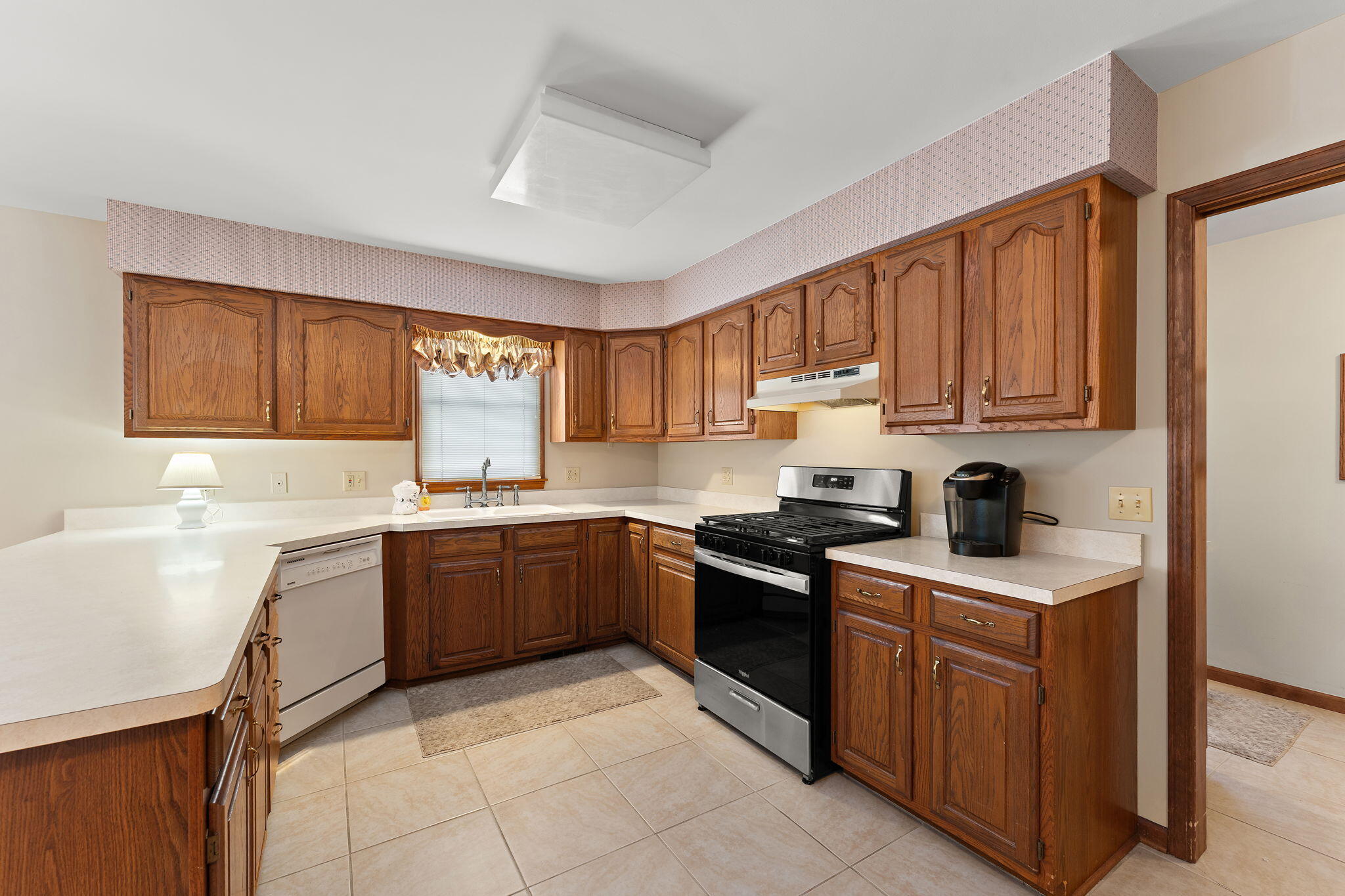 176 Wexford Road Valparaiso, IN 46385 - Photo 19 of 54 a kitchen with a stove sink and cabinets