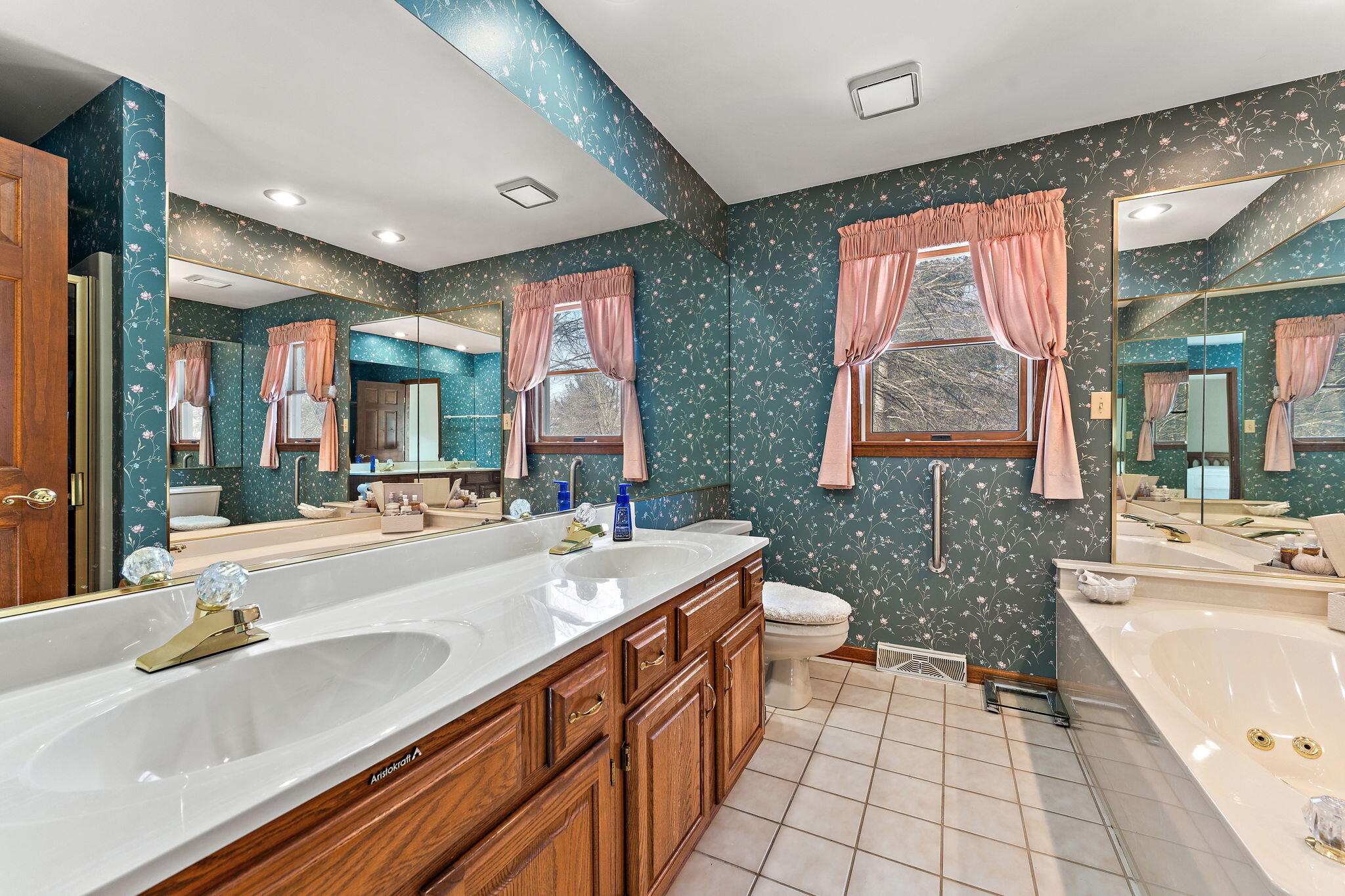 176 Wexford Road Valparaiso, IN 46385 - Photo 27 of 54 a spacious bathroom with a granite countertop sink mirror and a bathtub
