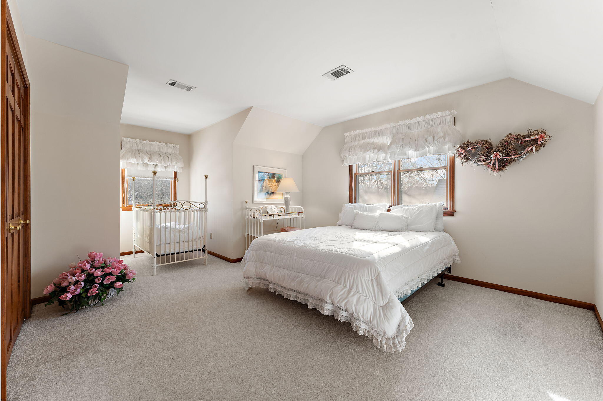 176 Wexford Road Valparaiso, IN 46385 - Photo 28 of 47 a spacious bedroom with a bed table and a potted plant
