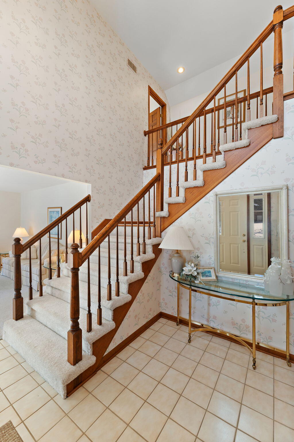 176 Wexford Road Valparaiso, IN 46385 - Photo 6 of 47 a view of staircase with lots of frames on wall and a window