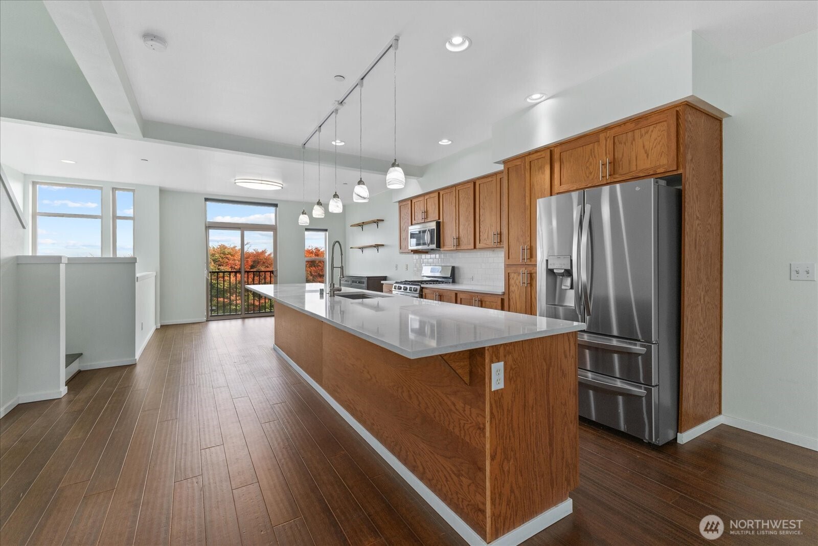 2132 South G Street Tacoma, WA 98405 - Photo 14 of 40 a kitchen with stainless steel appliances granite countertop a refrigerator a sink dishwasher a stove and white countertops with wooden floor