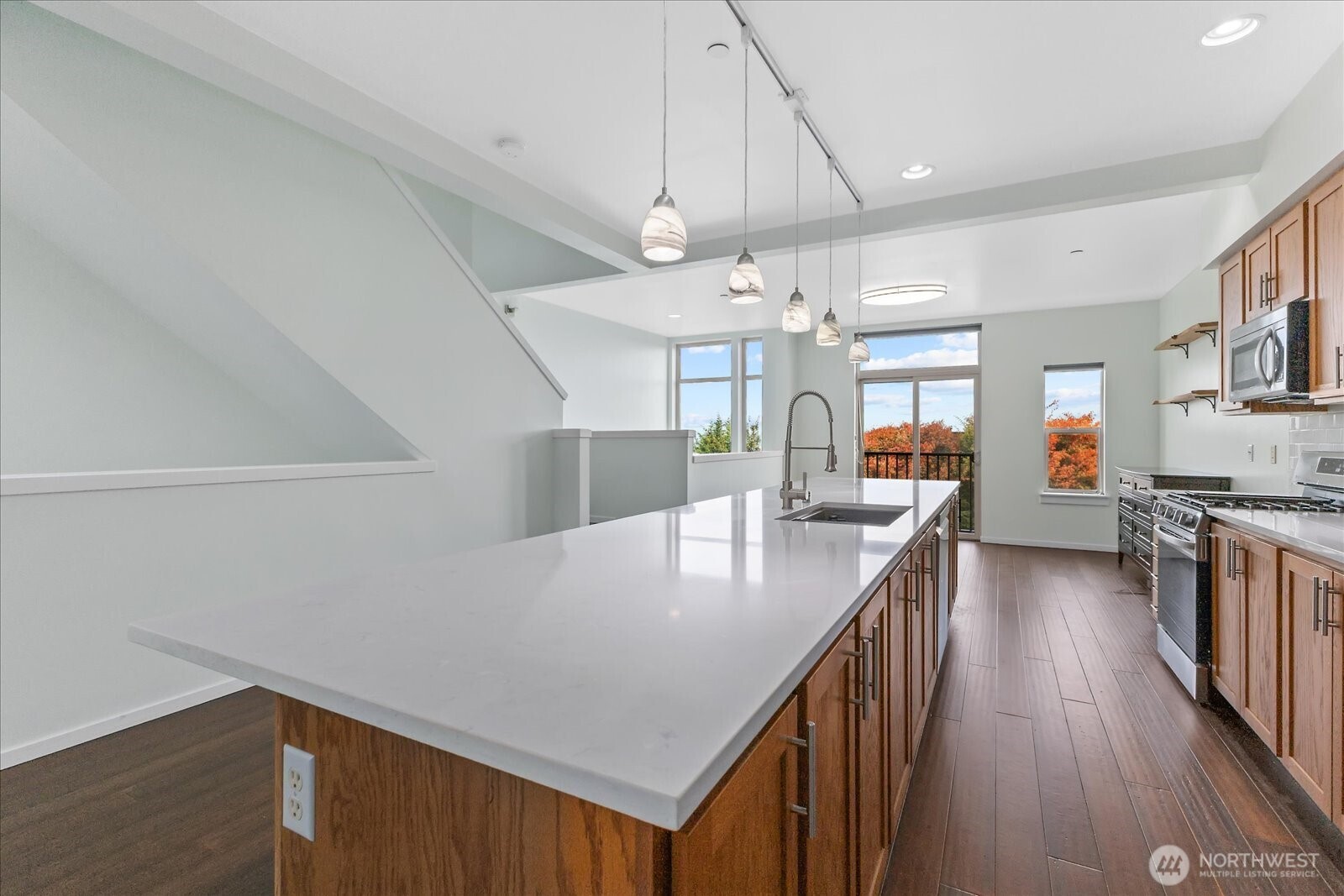 2132 South G Street Tacoma, WA 98405 - Photo 18 of 40 a kitchen with stainless steel appliances granite countertop a refrigerator a sink dishwasher a stove and a dining table with wooden floor