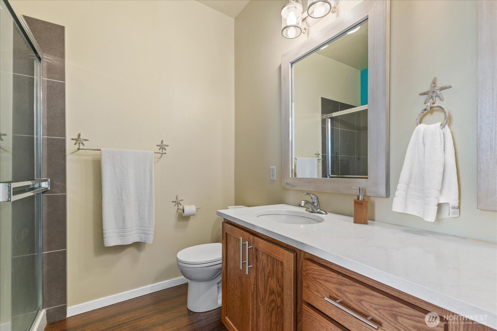 2132 South G Street Tacoma, WA 98405 - Photo 27 of 40 a bathroom with a sink a toilet and a mirror
