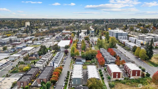 an aerial view of residential houses with city view