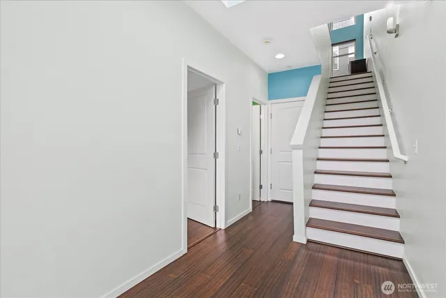 a view of a room with wooden floor and stairs