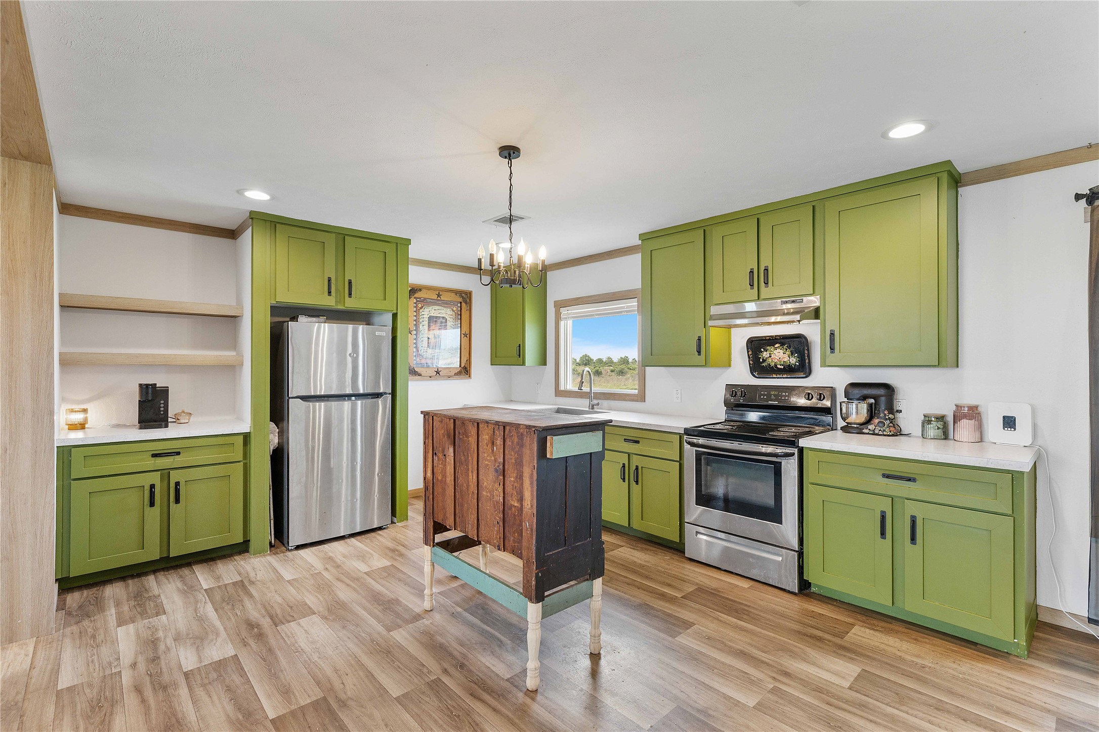 21550 Wilber Road Winnie, TX 77665 - Photo 14 of 28 a kitchen with cabinets a counter top space stainless steel appliances and a window