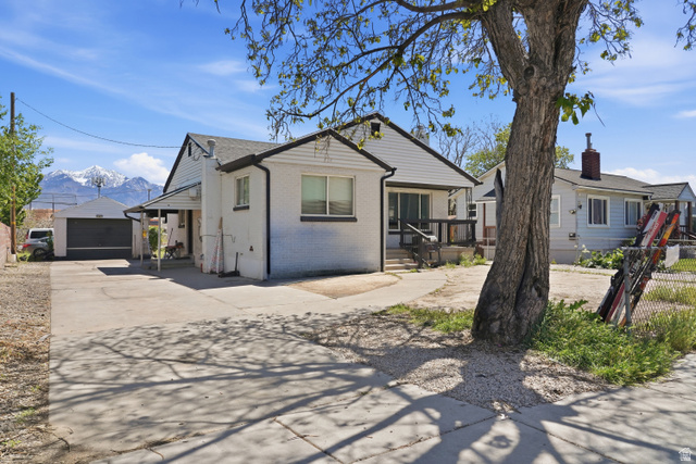7879 Oak Street Midvale, UT 84047 - Photo 29 of 32 White brick and siding exterior with dark trim and a covered front porch