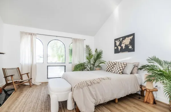 a bedroom with a bed and a table