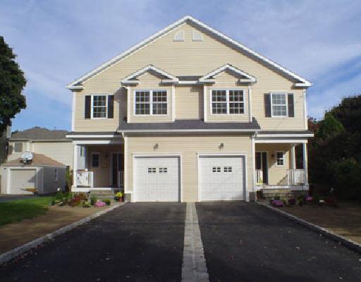 601 South Pine Creek Road Fairfield, CT 06824 - Photo 1 of 1 a view of a white house with large windows and a yard
