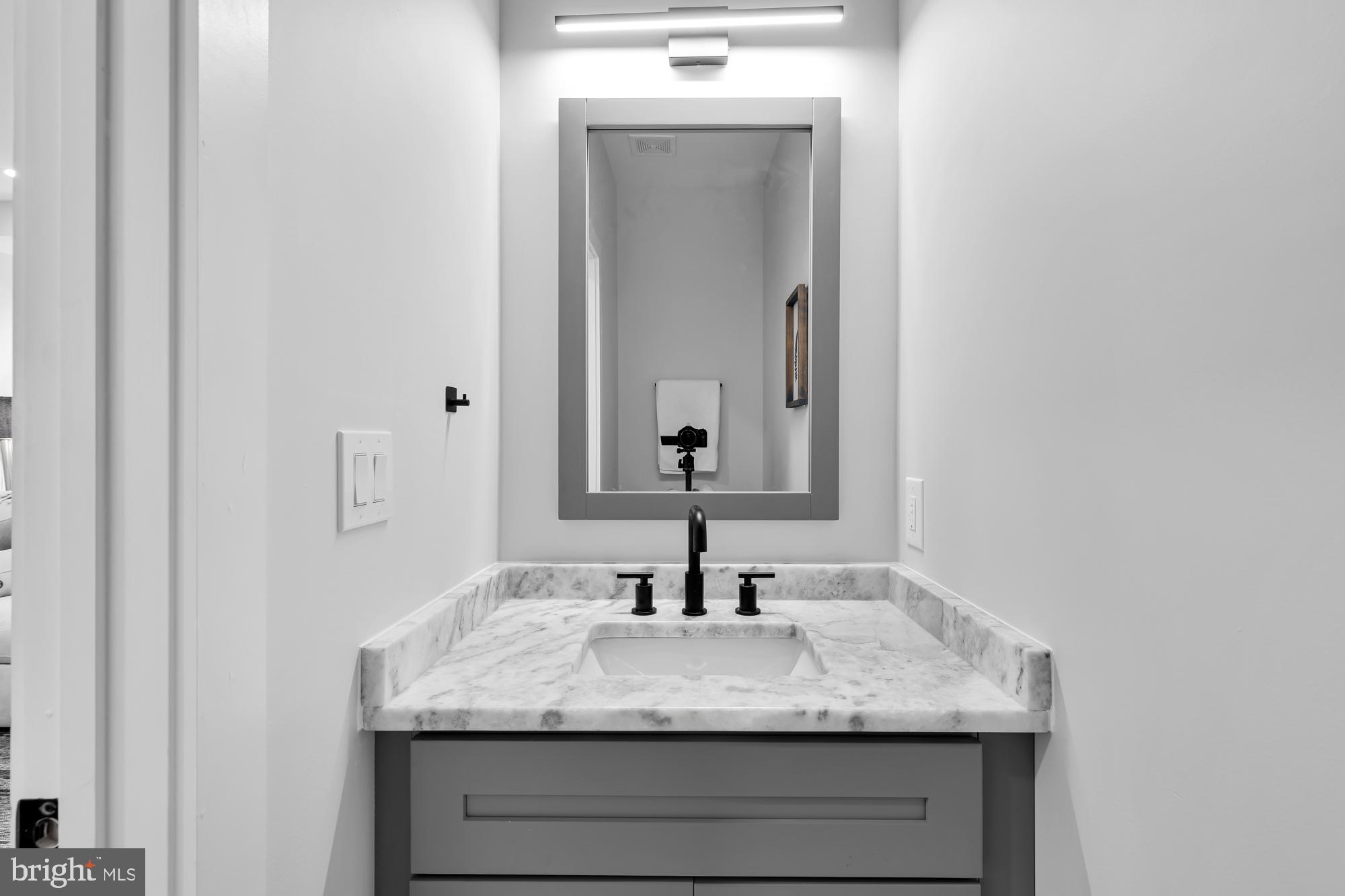 537 Park Road Northwest, Unit TH2 Washington, DC 20010 - Photo 13 of 60 a bathroom with a granite countertop sink and a mirror