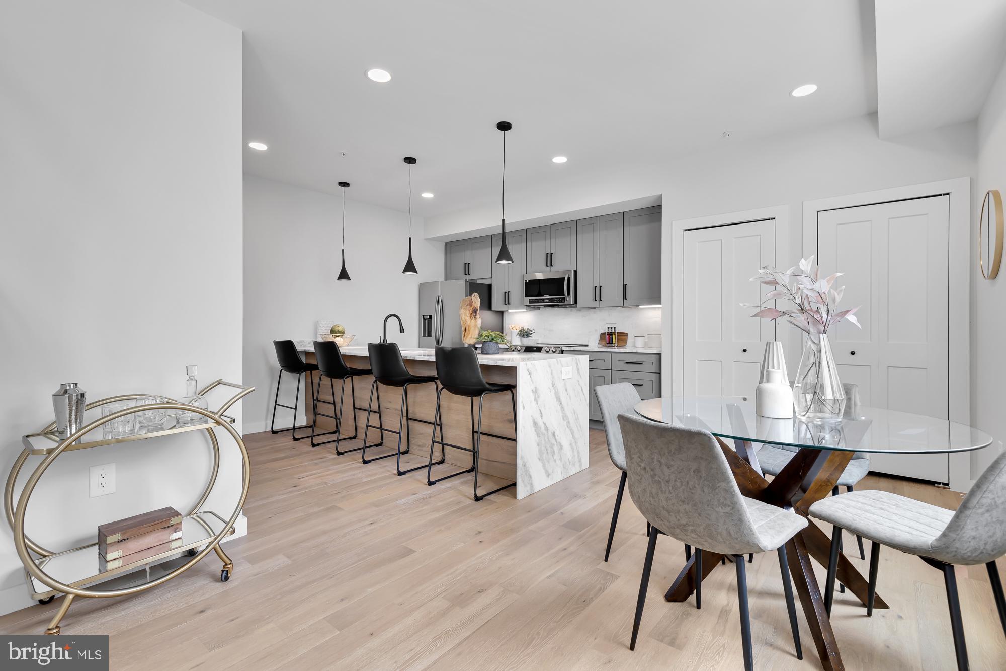 537 Park Road Northwest, Unit TH2 Washington, DC 20010 - Photo 15 of 60 a dining room with kitchen island a table and chairs