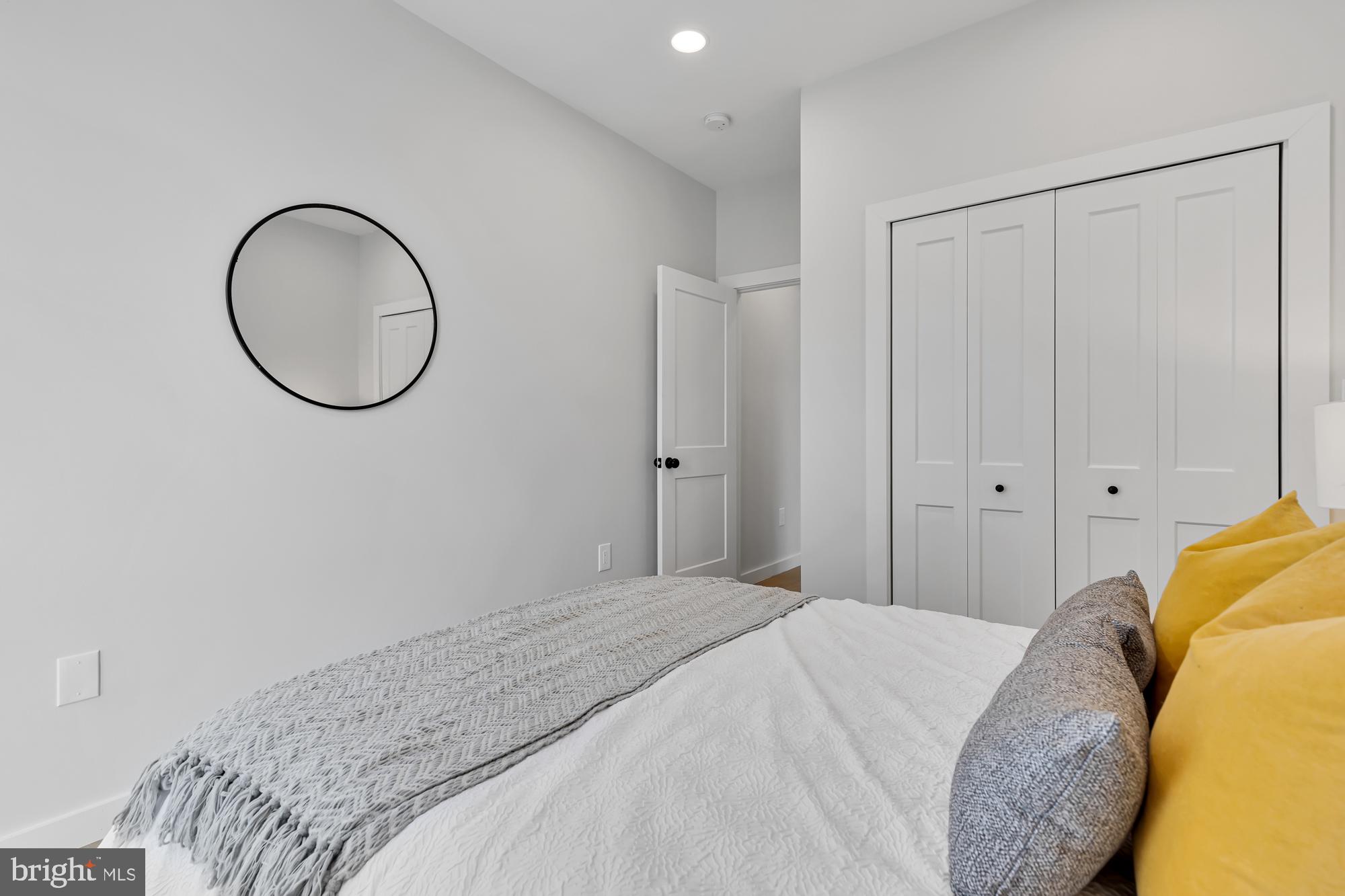 537 Park Road Northwest, Unit TH2 Washington, DC 20010 - Photo 31 of 60 a bedroom with a bed and a mirror
