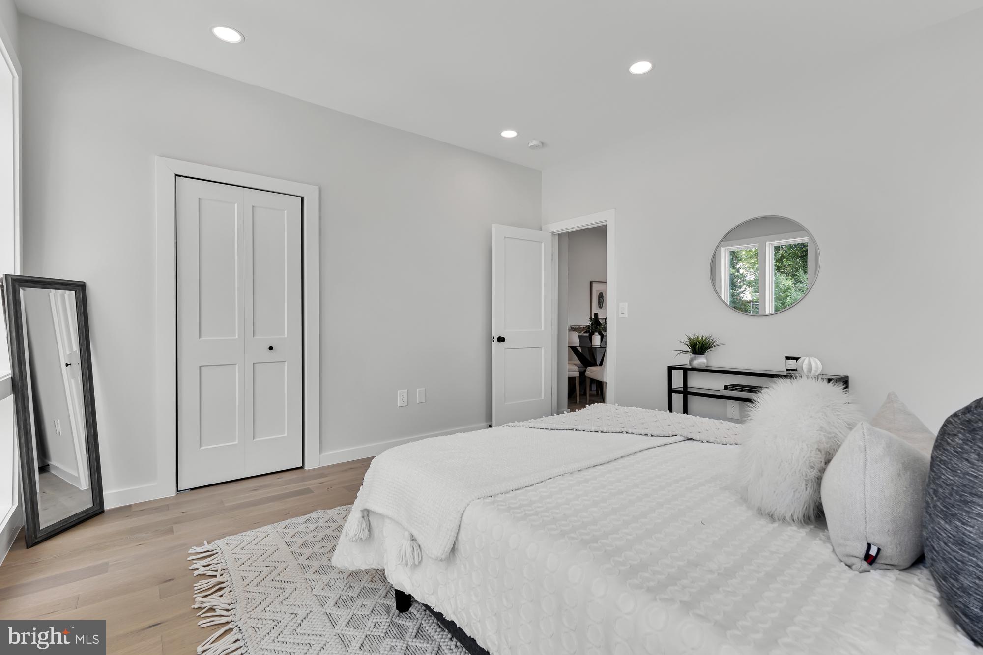 537 Park Road Northwest, Unit TH2 Washington, DC 20010 - Photo 44 of 60 a bedroom with a bed and a large mirror
