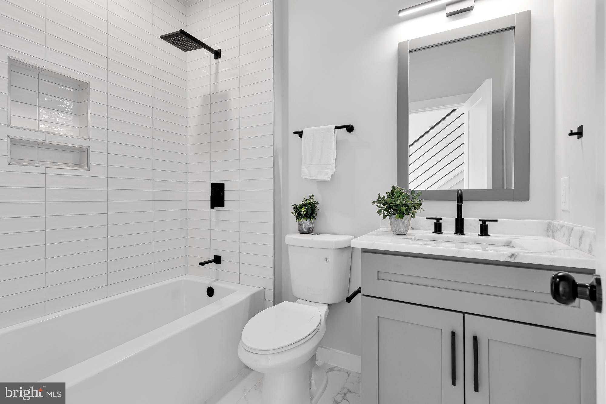537 Park Road Northwest, Unit TH2 Washington, DC 20010 - Photo 45 of 60 a bathroom with a sink mirror toilet and bathtub
