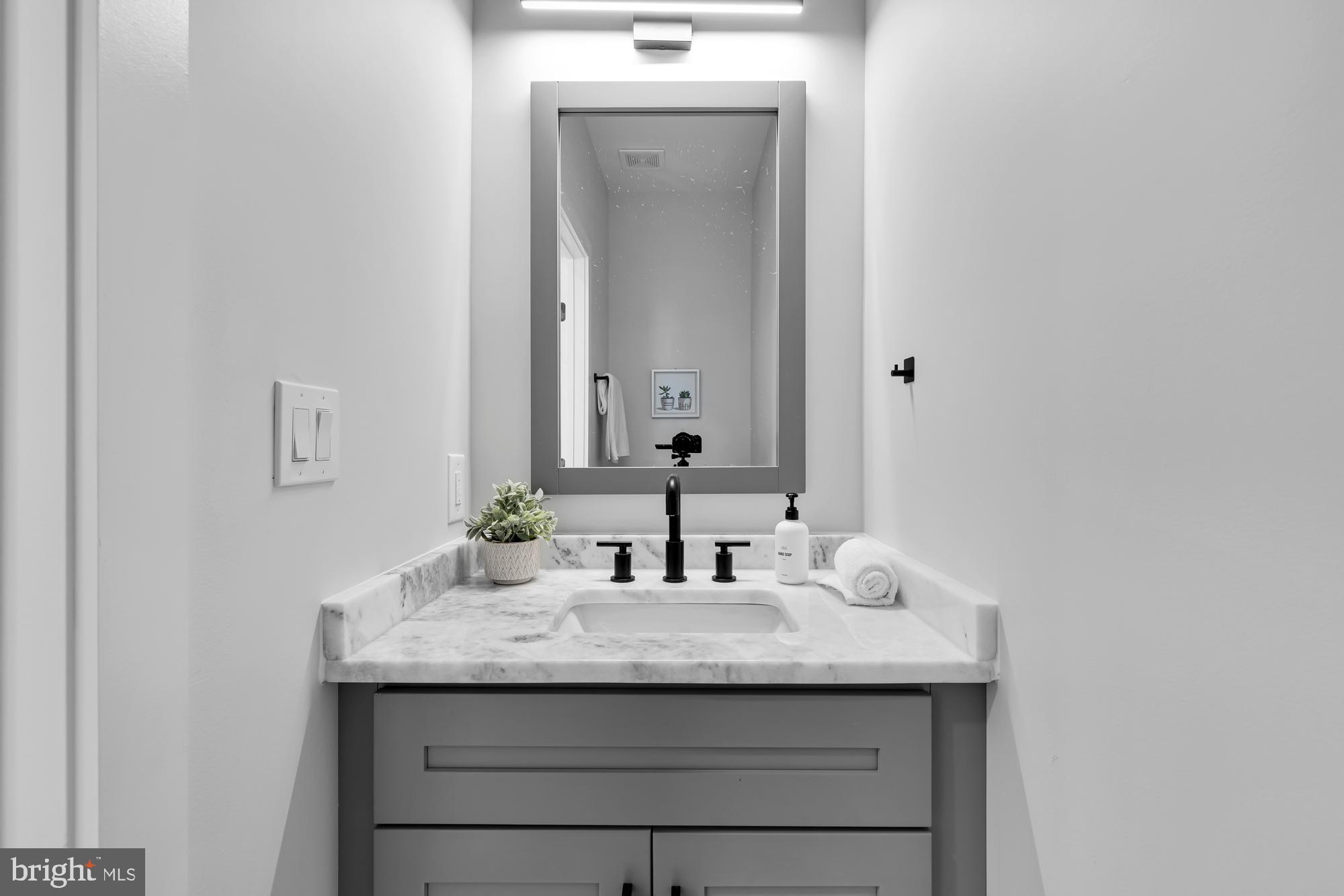 537 Park Road Northwest, Unit TH2 Washington, DC 20010 - Photo 51 of 60 a bathroom with a sink and a mirror