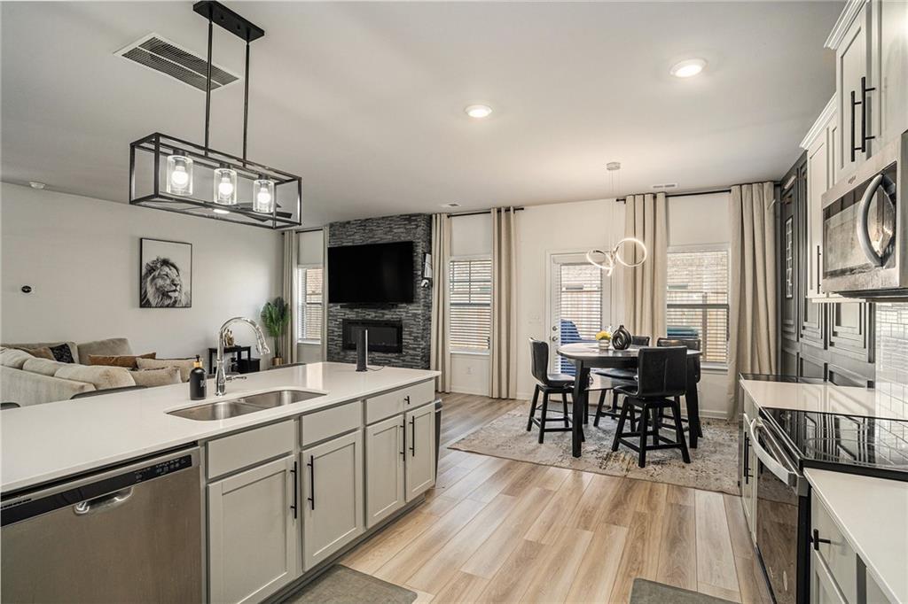 453 Sawmill Trace Hampton, GA 30228 - Photo 12 of 34 a kitchen with sink cabinets and dining table