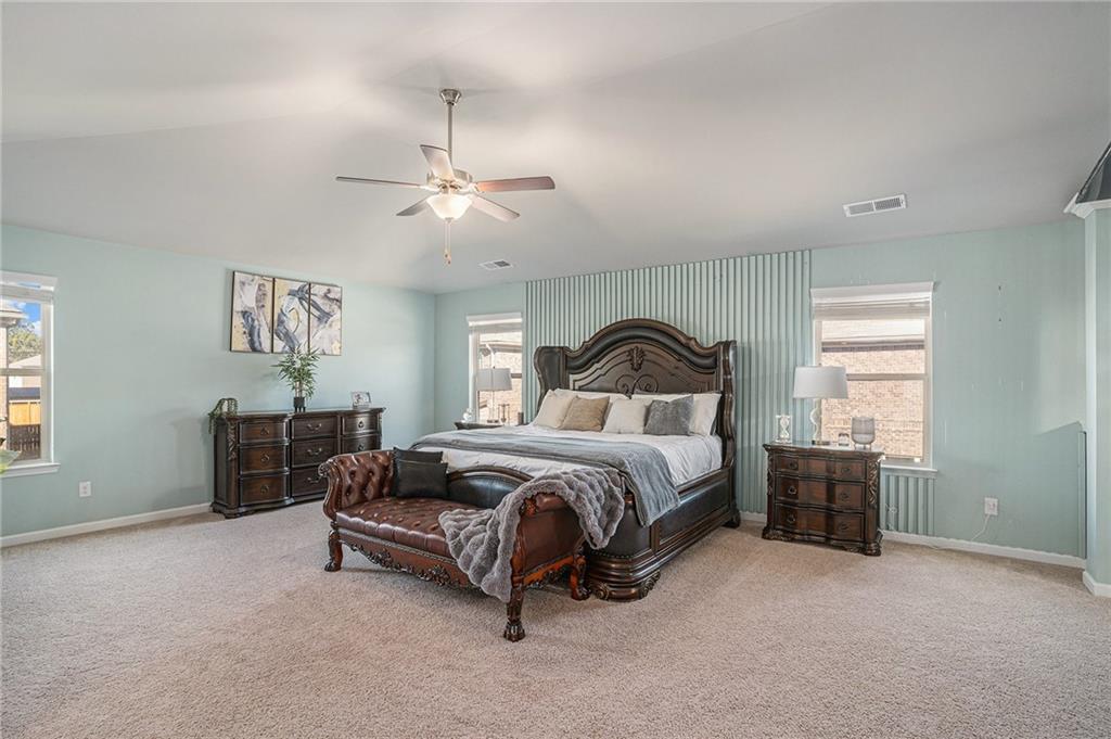 453 Sawmill Trace Hampton, GA 30228 - Photo 17 of 34 a bedroom with a bed and a chandelier