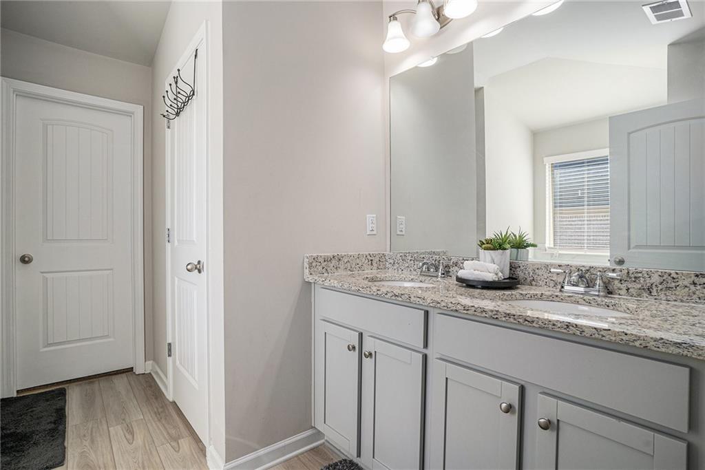 453 Sawmill Trace Hampton, GA 30228 - Photo 21 of 34 a bathroom with a granite countertop sink and a mirror