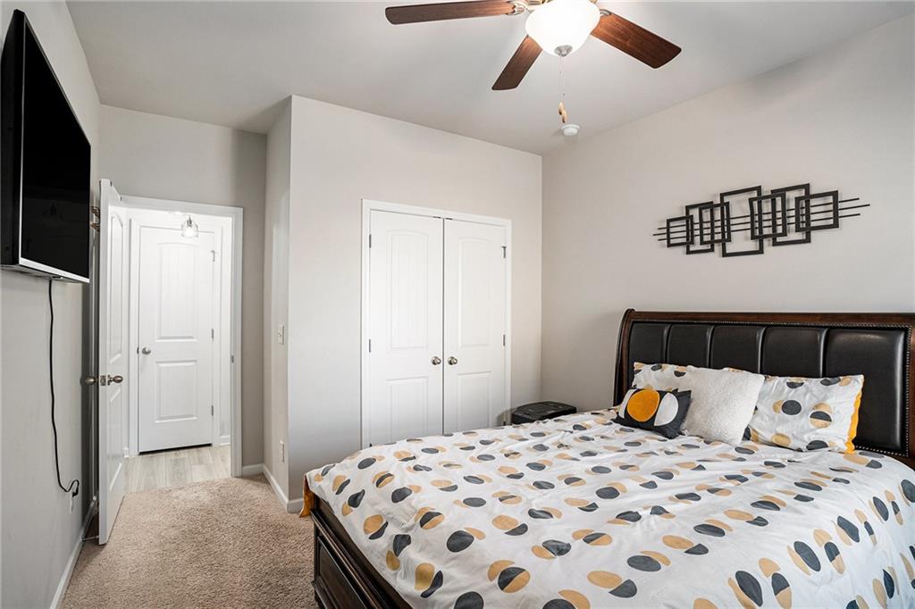 453 Sawmill Trace Hampton, GA 30228 - Photo 28 of 34 a bedroom with a bed and wooden floor