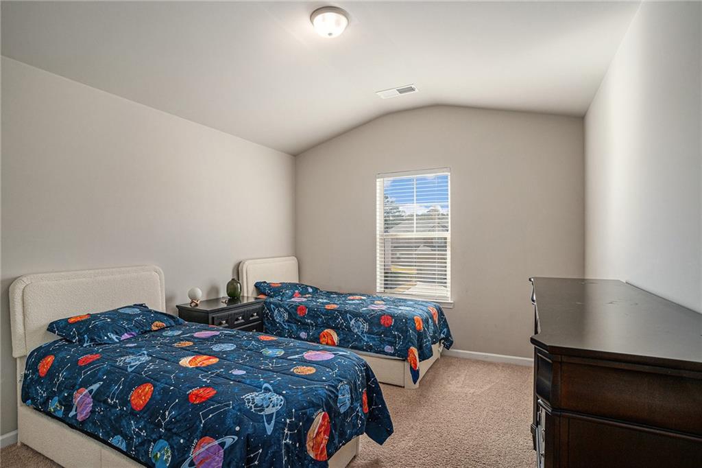 453 Sawmill Trace Hampton, GA 30228 - Photo 29 of 34 a bedroom with a bed and a window