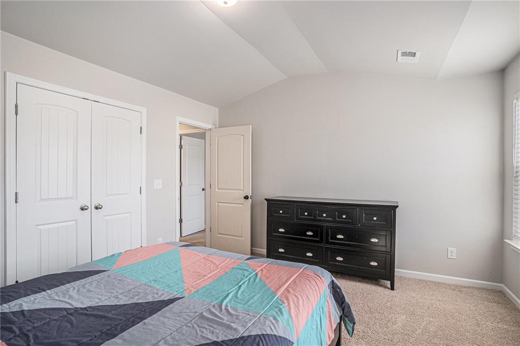 453 Sawmill Trace Hampton, GA 30228 - Photo 32 of 34 a bedroom with a bed and a dresser