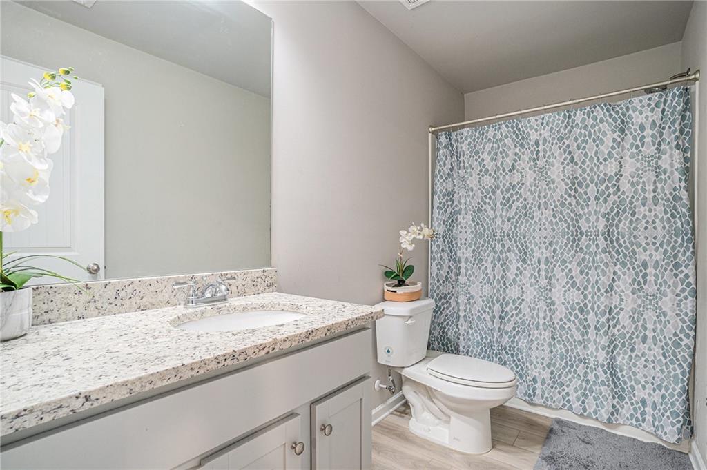 453 Sawmill Trace Hampton, GA 30228 - Photo 33 of 34 a bathroom with a granite countertop sink mirror vanity and toilet