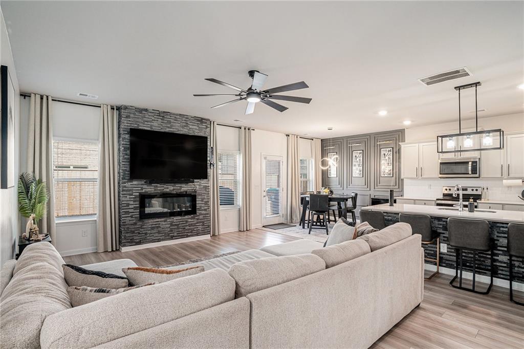 453 Sawmill Trace Hampton, GA 30228 - Photo 7 of 34 a living room with furniture and a flat screen tv