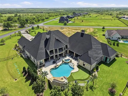 an aerial view of a house with outdoor space and a lake view
