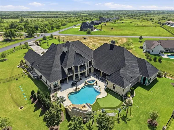 an aerial view of a house with outdoor space and a lake view