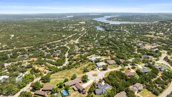 an aerial view of residential houses with city view