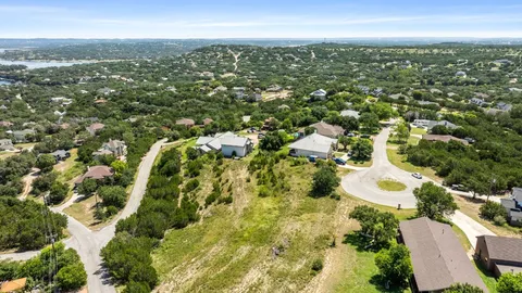 an aerial view of residential houses with city view